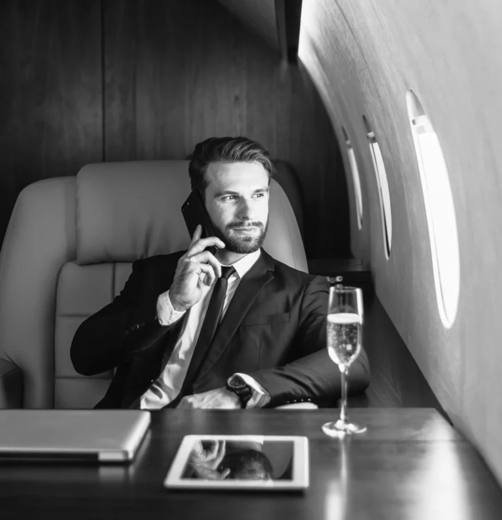 Man in a suit taking a phone call, in black and white