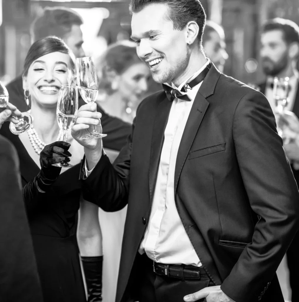 Couple laughing at an evening event, in black and white